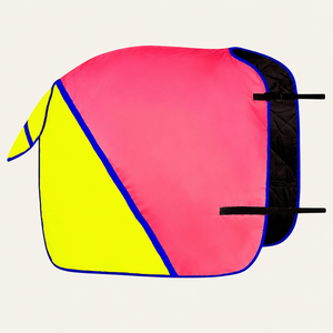 A colorful horse blanket with a geometric design featuring a bright pink body, a neon yellow panel on the left, and blue piping borders, shown on a light cream background.