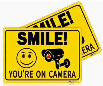 Smile You Are On Camera sign.